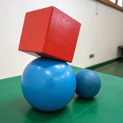 Recraft V3 — A red cube on top of a blue sphere, both sitting o