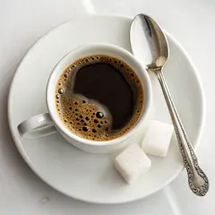 Recraft V3 — A cup of coffee on a saucer, with a spoon to the r