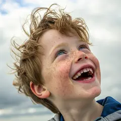 Recraft V3 — A freckled boy with bright blue eyes and messy hai