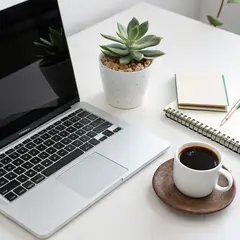 Recraft V3 — A sleek laptop on a clean white desk with a potted