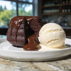 Recraft V4 — A dripping chocolate lava cake cut open on a white