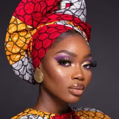 Recraft V4 — A woman with elaborate gele headwrap and bold eye 