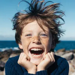 Recraft V4 — A freckled boy with bright blue eyes and messy hai