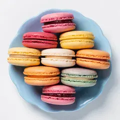 Recraft V4 — A stack of colorful macarons on a pastel blue plat