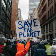 Recraft V4 — A protest sign held up in a crowd reading SAVE THE