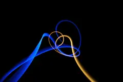 Reve v1.0 — Intertwining ribbons of light in blue and gold aga
