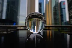 Reve v1.0 — A glass sphere refracting a distorted cityscape, s