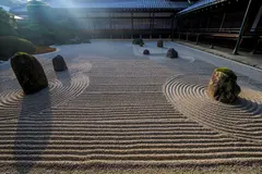 Reve v1.0 — A Japanese zen garden with raked gravel, moss-cove