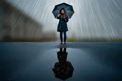 Reve v1.0 — A woman holding an umbrella in the rain, reflected