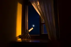 Reve v1.0 — A telescope pointing at the moon through an open w