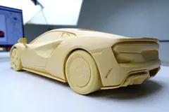 Reve v1.0 — A clay render of a sports car, white material, stu
