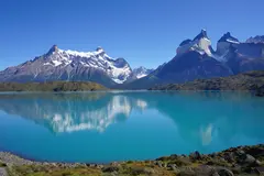 Reve v1.0 — A turquoise glacial lake surrounded by snow-capped