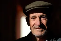 Reve v1.0 — An elderly man with a weathered face and kind smil