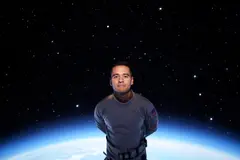 Reve v1.0 — An astronaut without a helmet, face lit by Earth g