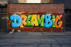 Reve v1.0 — A graffiti mural on a brick wall spelling DREAM BI