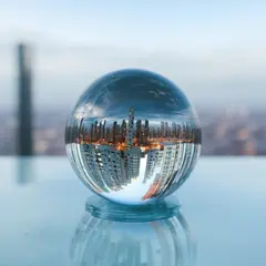 SD 3.5 Large — A glass sphere refracting a distorted cityscape, s