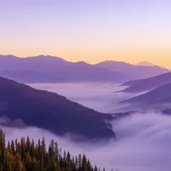 SD 3.5 Large — A misty mountain range at sunrise, layers of purpl