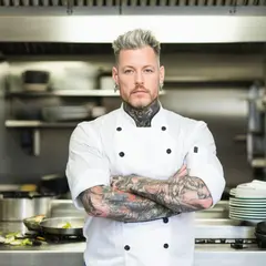 SD 3.5 Large — A tattooed chef in a white coat, arms crossed, con