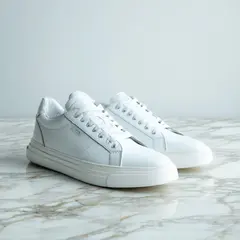 SD 3.5 Large — A pair of white leather sneakers on a marble count