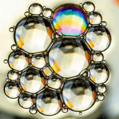 Seedream v4.5 — A macro photograph of oil droplets on water, iride