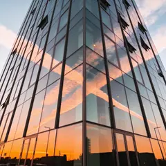 Seedream v4.5 — A modern glass skyscraper reflecting clouds at sun