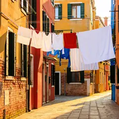 Seedream v4.5 — A narrow cobblestone alley in Venice with colorful