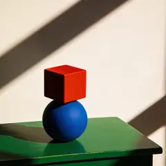 Seedream v4.5 — A red cube on top of a blue sphere, both sitting o