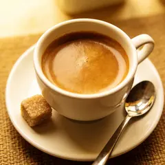 Seedream v4.5 — A cup of coffee on a saucer, with a spoon to the r