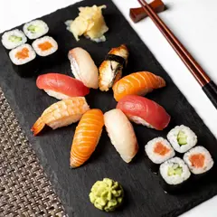 Seedream v4.5 — A perfectly plated sushi omakase on a black slate 