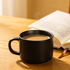 Seedream v4.5 — A matte black coffee mug with steam rising, placed