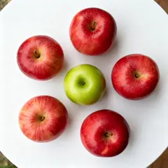 Seedream v4 — Five red apples arranged in a circle on a white ta