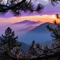 Seedream v4 — A misty mountain range at sunrise, layers of purpl