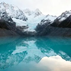 Seedream v4 — A turquoise glacial lake surrounded by snow-capped