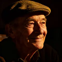 Seedream v4 — An elderly man with a weathered face and kind smil