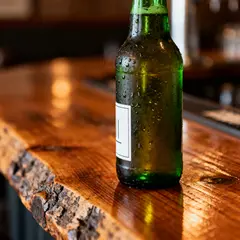 Seedream v4 — A green glass bottle of craft beer with condensati