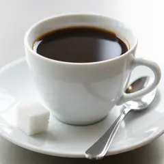 Wan 2.6 T2I — A cup of coffee on a saucer, with a spoon to the r