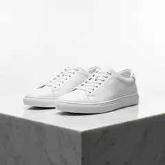 Wan 2.6 T2I — A pair of white leather sneakers on a marble count
