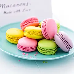 Wan 2.6 T2I — A stack of colorful macarons on a pastel blue plat