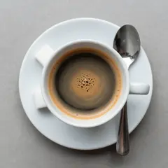 Z-Image Turbo — A cup of coffee on a saucer, with a spoon to the r