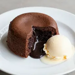 Z-Image Turbo — A dripping chocolate lava cake cut open on a white