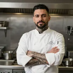 Z-Image Turbo — A tattooed chef in a white coat, arms crossed, con